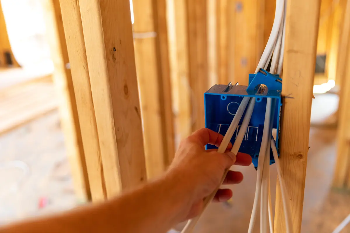 An outlet box and wiring installed in an unfinished stud wall