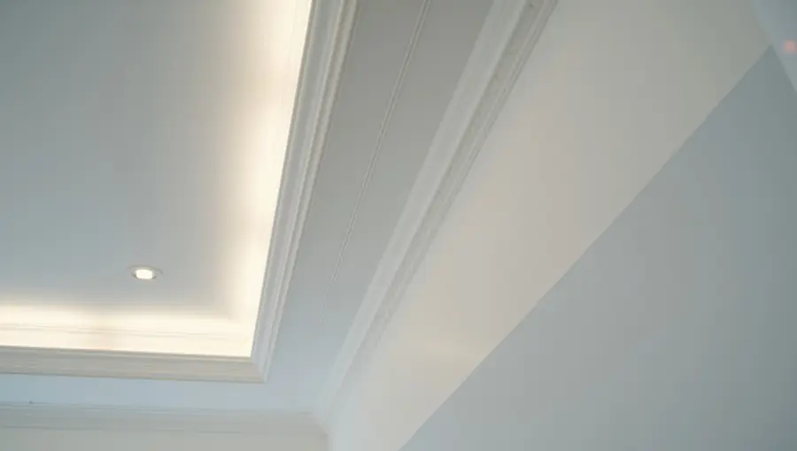 Recessed downlights and cove lighting in a coffered ceiling